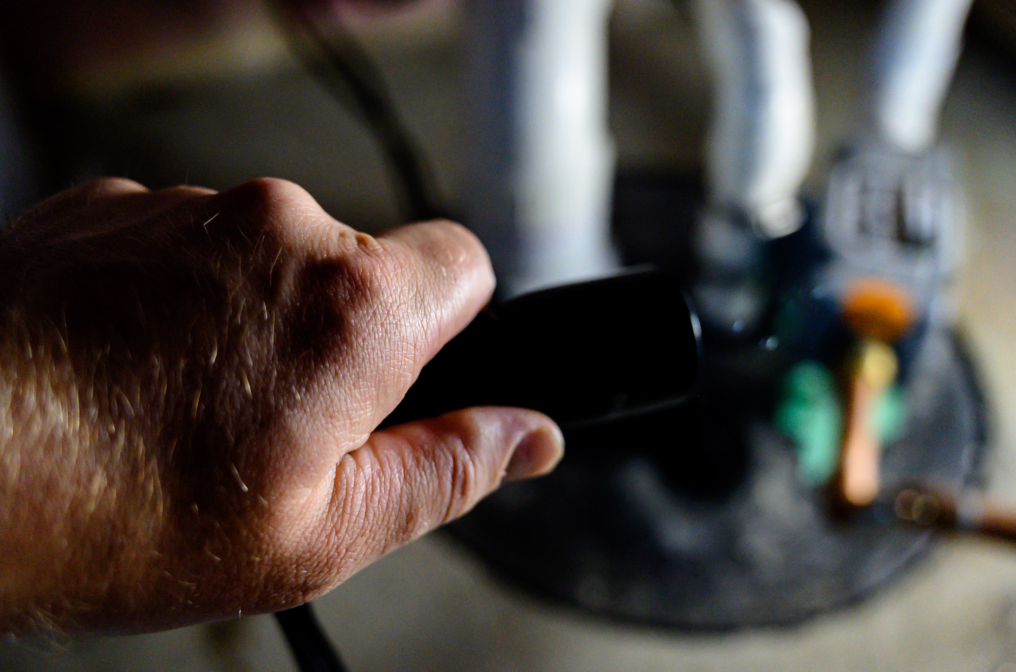 a hand holding a black object